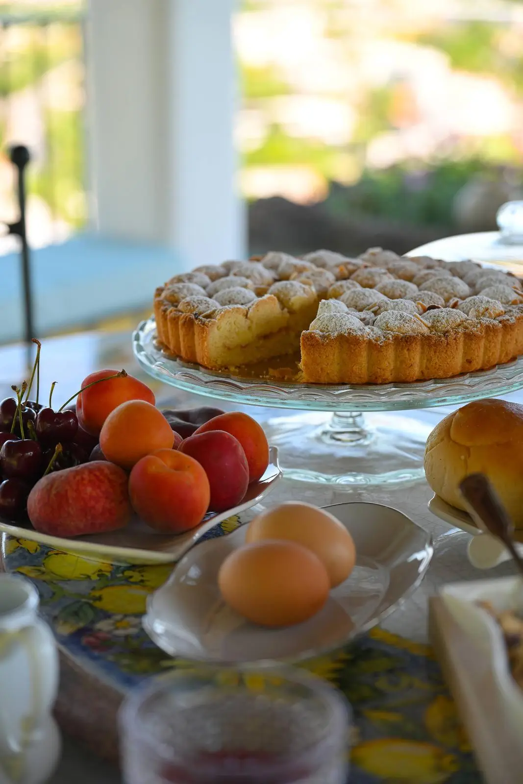 Apricots, cherries and fresh eggs beside the buffet pastries