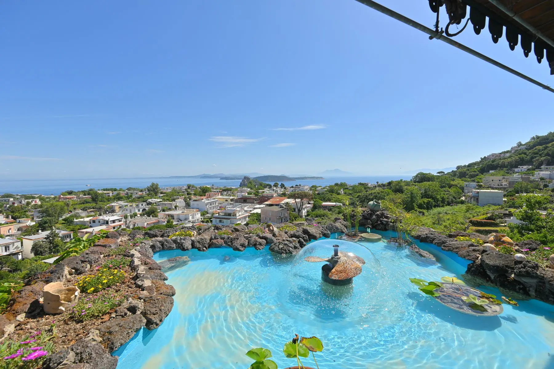 The blue water among the volcanic rocks with water lilies and the gulf beyond