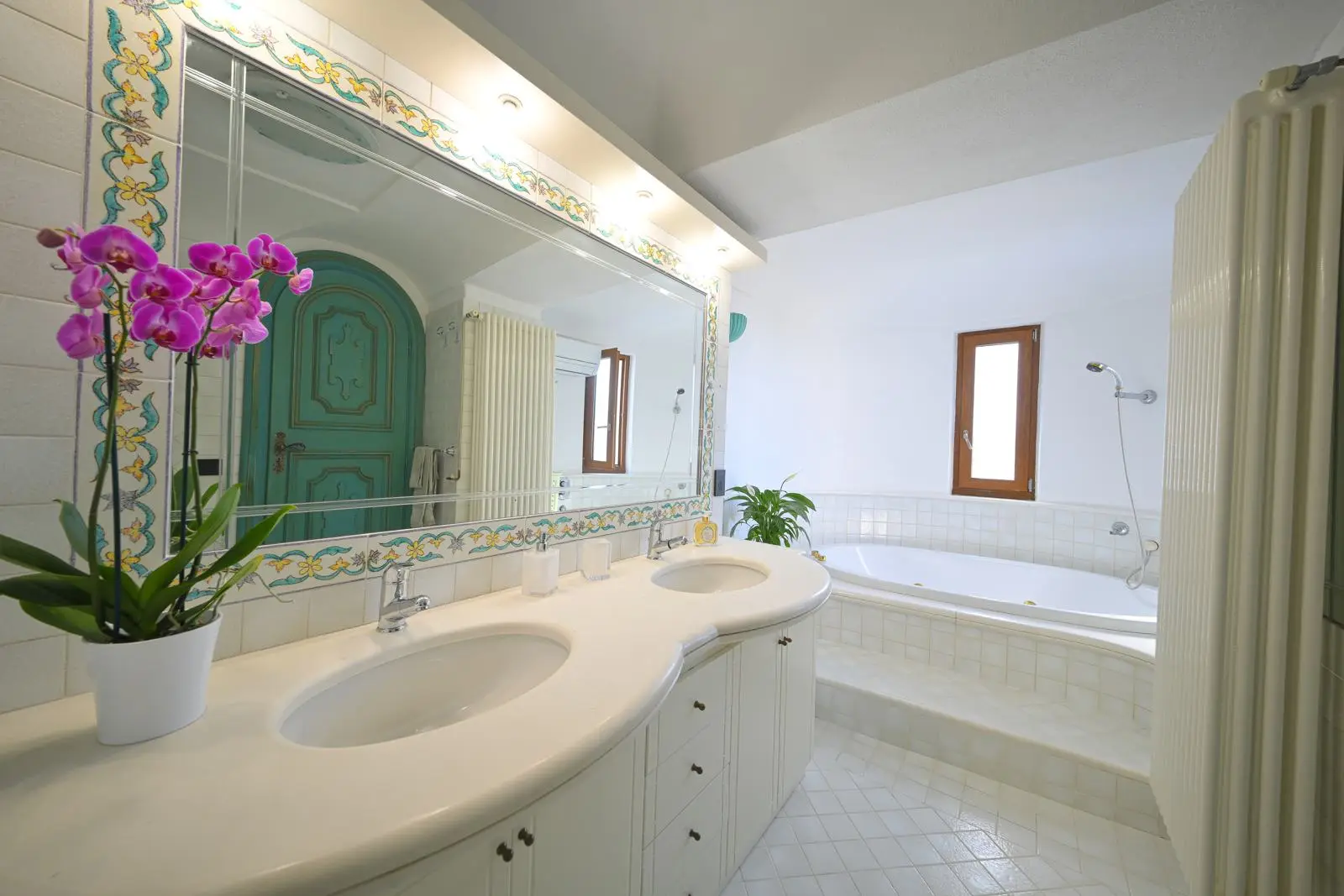 The bathroom with double basin, mirror and orchids
