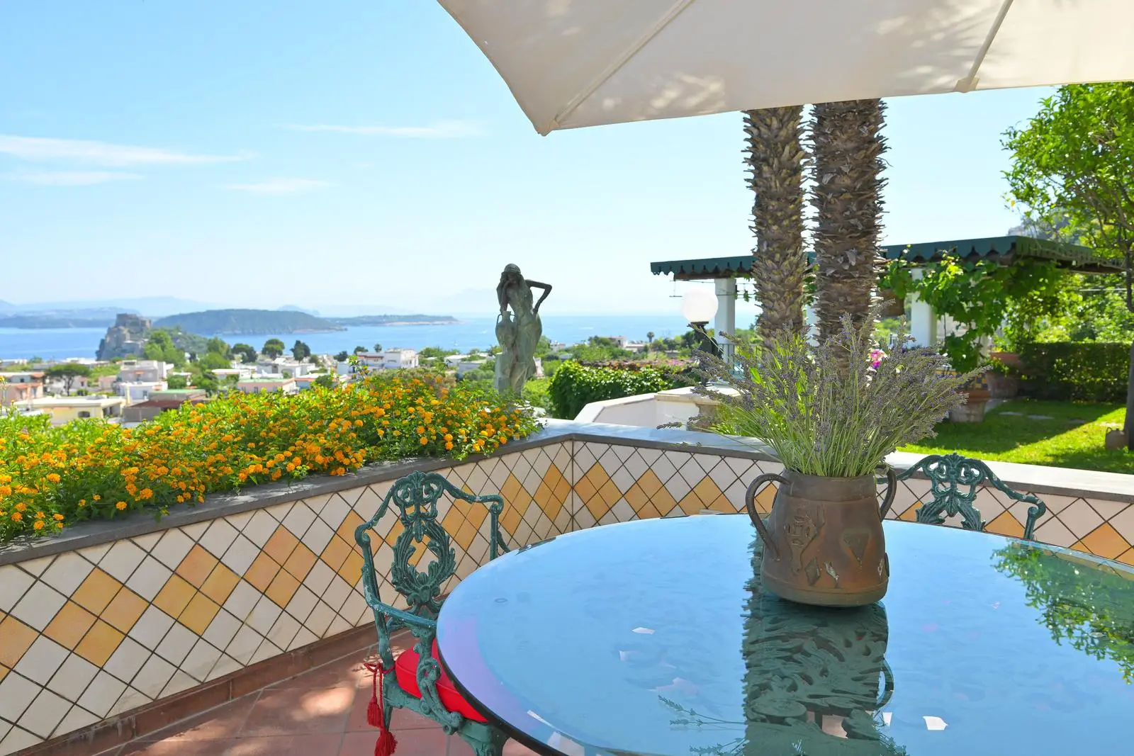 The terrace table with a vase of lavender and the bay beyond